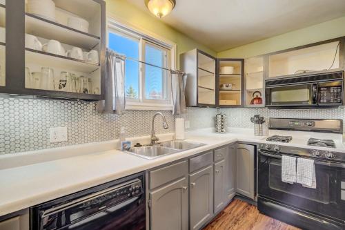 a kitchen with a sink and a stove at 3BR MTN Views Downtown Next to Lake Parks & More in Colorado Springs