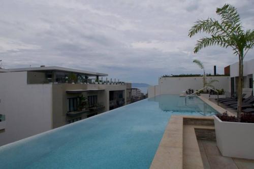 a large swimming pool on the side of a building at Urban by Pardela in Puerto Vallarta