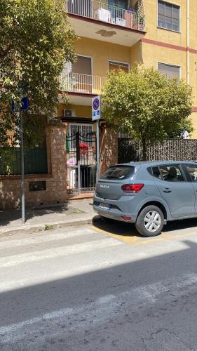 a silver car parked in front of a building at home josèphine in Caserta