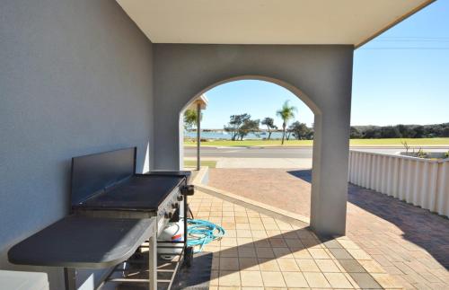 a patio with an archway and a ping pong table at Kalbarri Waters A - Kalbarri WA in Kalbarri