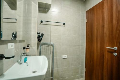 a bathroom with a sink and a shower at Darki Apartments 2 - Very Central Stay With Free Parking in Ohrid