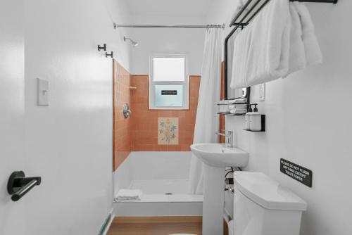 uma casa de banho com um chuveiro, um WC e um lavatório. em Aliza Hotel em Los Angeles