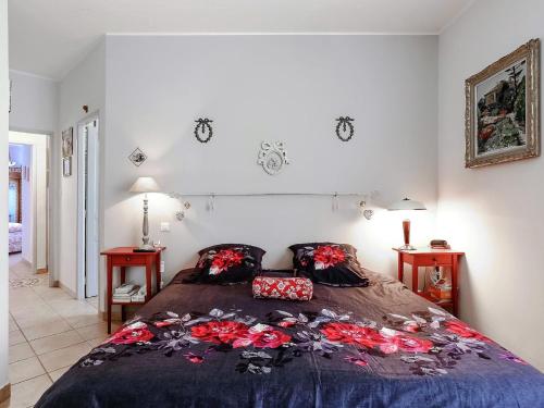 a bedroom with a bed with a blue comforter at Le Cezanne in Aix-en-Provence