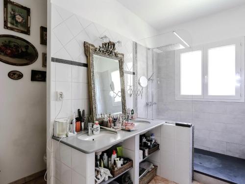 a bathroom with a sink and a mirror at Le Cezanne in Aix-en-Provence