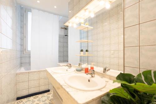 a bathroom with a sink and a mirror at Luxury Parisian Apartment NOTRE DAME SAINT GERMAIN DES PRES in Paris