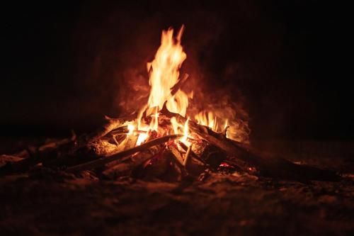 a bonfire is lit up at night at Watu Kite House in Mayapo
