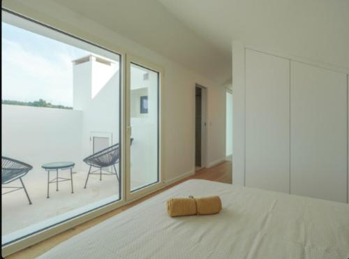 a bedroom with a bed and a large window at Villa Emerald Oeiras Lisbon in Oeiras