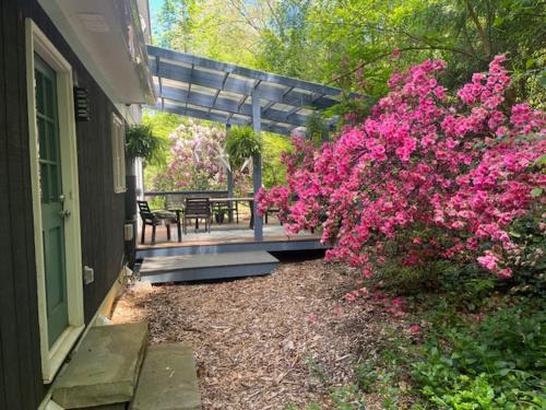 a porch with pink flowers on a house at Family launchpad in Asheville