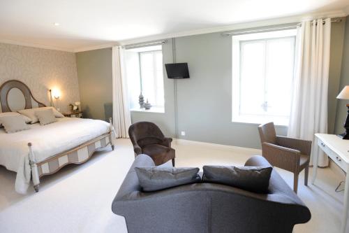 a living room with a couch and a bed at Demeures & Châteaux, La Ferme des Mares in Saint-Germain-sur-Ay