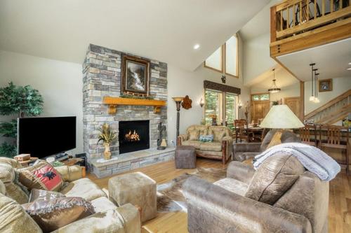 a living room with couches and a fireplace at Three-Bedroom Apartment in Estes Park