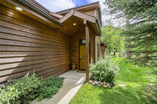 a wooden house with a door in a yard at Three-Bedroom Apartment in Estes Park