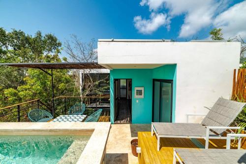 a villa with a swimming pool and a house at CHIC 3-Levels at MUN - Rooftop Deck - Pool in Tulum