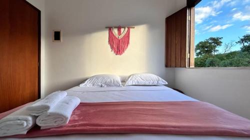 a bedroom with a large bed with a window at Pousada Estrelar in Lençóis