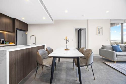 a kitchen and dining room with a table and chairs at City&Bridge View 2 Bed+Study in Homebush in Sydney