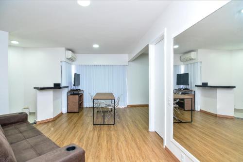 a living room with a couch and a table at Flat Fortune Jardins in Sao Paulo