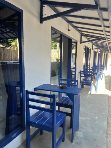 a blue table and chairs on a patio at Hostel Gili Trawangan in Gili Trawangan