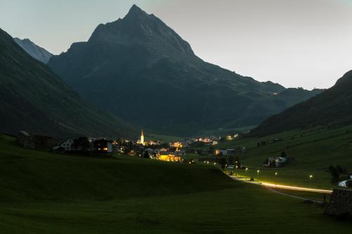 a town on a hill with a mountain in the background at Apart Renate in Galtür