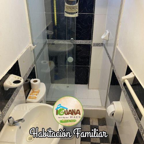a small bathroom with a toilet and a shower at IGUANA HAUS IQUITOS in Iquitos
