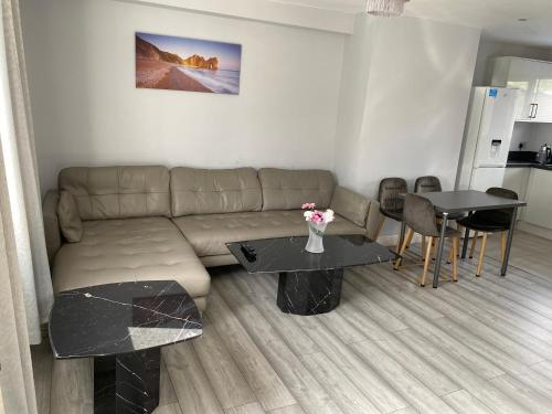 a living room with a couch and a table at 3 Bedroom House in Loughborough in Loughborough