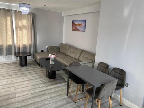 a living room with a couch and a table at 3 Bedroom House in Loughborough in Loughborough