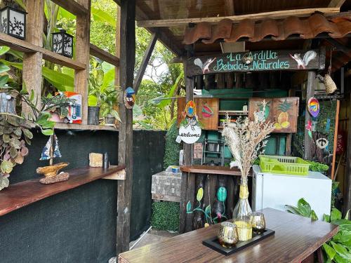 a garden shop with a table and some plants at Hostel Rústico MarAbi in Tarcoles