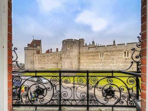 a castle with a fence in front of it at Harte and Garter Hotel in Windsor