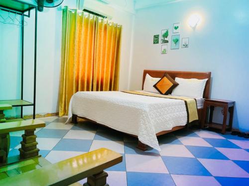a bedroom with a bed and a checkered floor at Thắng Lợi Hotel in Thanh Hóa