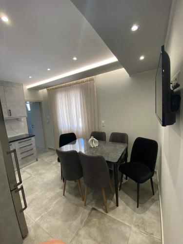 a dining room with a table and chairs at THE WAVE HOUSE in Skala Sotiros