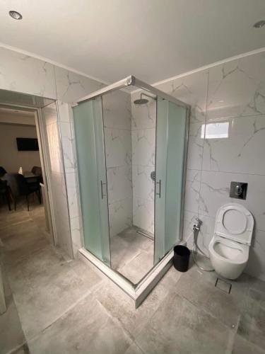 a bathroom with a toilet and a glass shower at THE WAVE HOUSE in Skala Sotiros