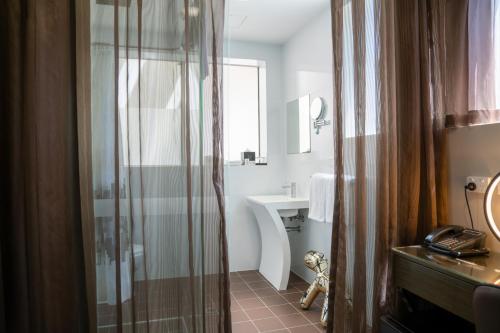 a bathroom with a shower and a sink at 57Hotel in Sydney