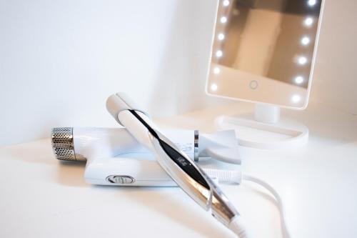 a desk with a toothbrush and a computer monitor at Of Hotel in Sendai