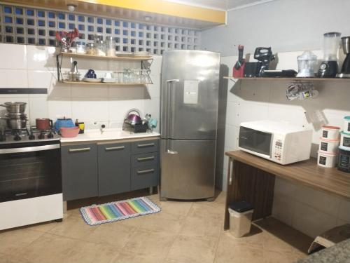 a kitchen with a stainless steel refrigerator and a counter at Hostel 940 in Sinop