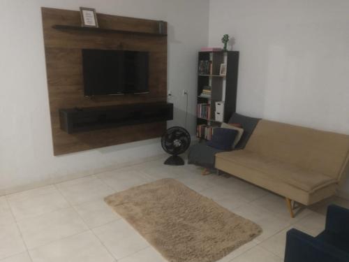 a living room with a couch and a flat screen tv at Hostel 940 in Sinop