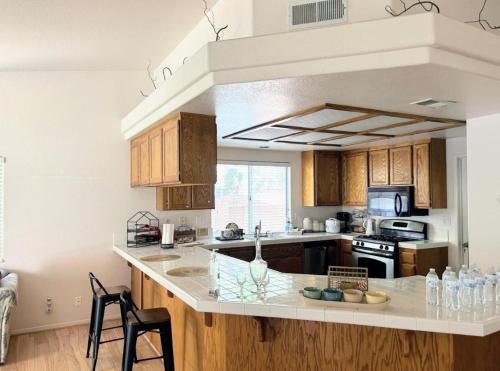 a kitchen with wooden cabinets and a counter top at Western Horizon Home in Hemet