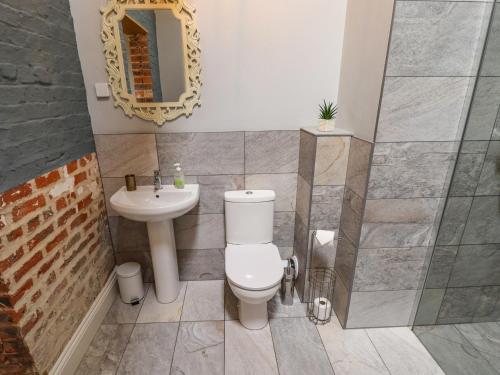 a bathroom with a toilet and a sink at Little Owl in Market Rasen