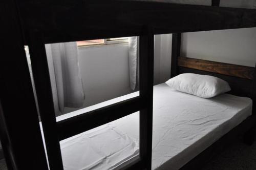 a view of a bunk bed with a pillow on it at La Clave Hostel in Cali