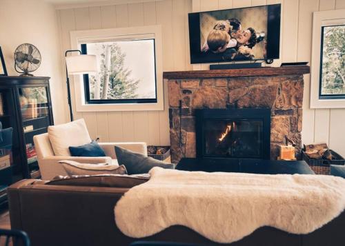 a living room with a couch and a fireplace at Modern Luxury Cabin - Hot Tub, Hiking, Hammocks in Cascade-Chipita Park