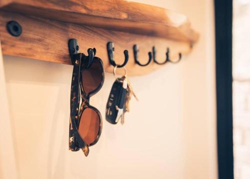 a group of sunglasses hanging on a door at Modern Luxury Cabin - Hot Tub, Hiking, Hammocks in Cascade-Chipita Park