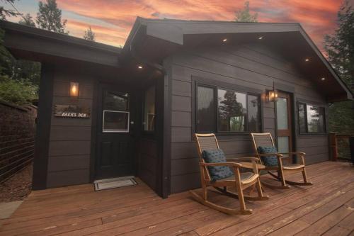 a small house with two chairs on a deck at Modern Luxury Cabin - Hot Tub, Hiking, Hammocks in Cascade-Chipita Park