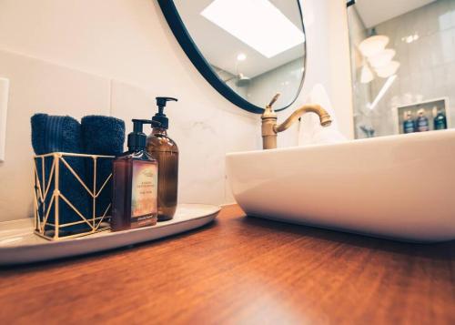 a bathroom counter with a sink and a mirror at Modern Luxury Cabin - Hot Tub, Hiking, Hammocks in Cascade-Chipita Park