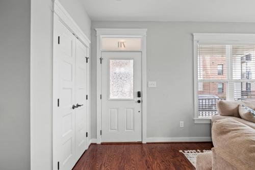 a living room with white walls and a white door at Richmond Gem, Free Parking, Quiet, Fenced,Walkable in Richmond