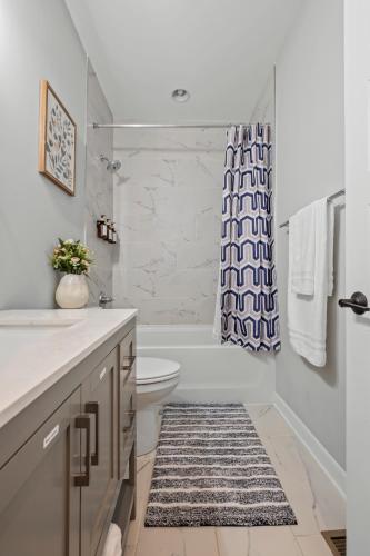 a bathroom with a toilet and a shower curtain at Richmond Gem, Free Parking, Quiet, Fenced,Walkable in Richmond