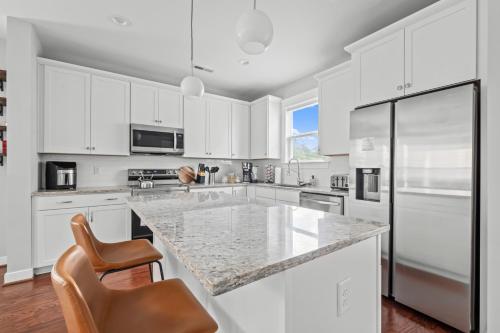 a kitchen with white cabinets and a granite counter top at Richmond Gem, Free Parking, Quiet, Fenced,Walkable in Richmond