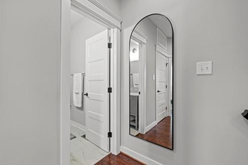 a bathroom with a mirror and white cabinets at Richmond Gem, Free Parking, Quiet, Fenced,Walkable in Richmond
