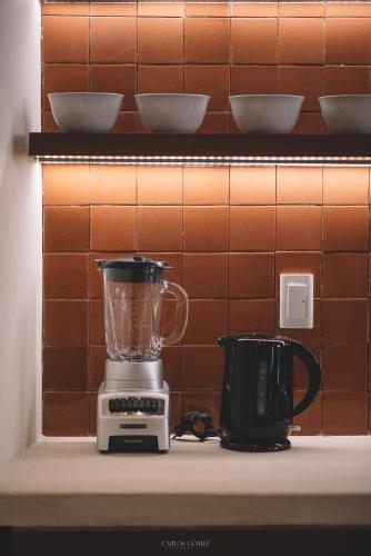 a blender on a shelf next to a coffee maker at Casa Alicia @ Downtown in Mazatlán