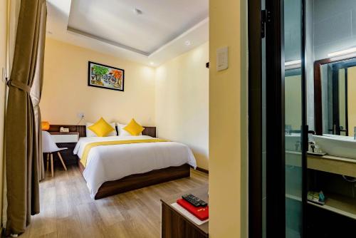 a hotel room with a bed and a sink at Green Hill Hotel in Hoi An