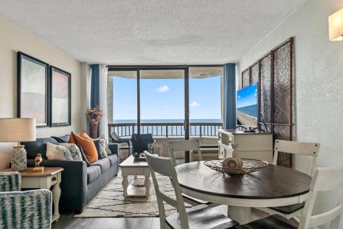 a living room with a couch and a table at Nicely Renovated 1 Bedroom Condo-With Spectacular Views! Pinnacle 755 in Myrtle Beach