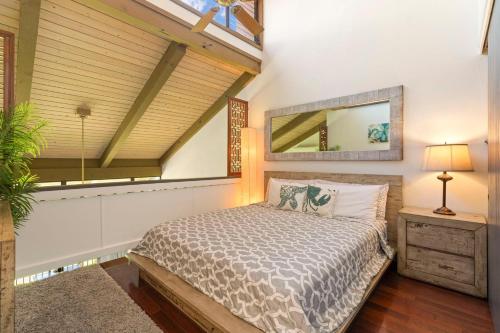 a bedroom with a bed and a mirror on the wall at Luana Kai Loft C308 BY Betterstay in Kihei