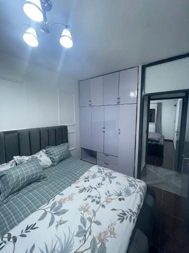 a bedroom with a bed and a large window at Danin Real-estates in Douala
