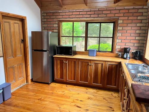 eine Küche mit einem Kühlschrank aus Edelstahl und einem Fenster in der Unterkunft Kappering Retreat in Portland